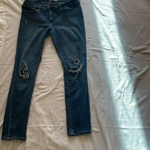 Levi Strausss blue denim distressed skinny jeans. 
Size 29 snug fit mid rise